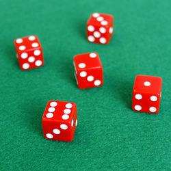 High angle view of red dice on green table