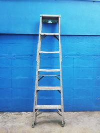 Metallic structure against blue wall of house