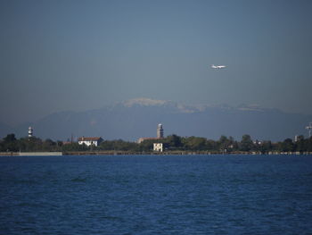 Lighthouse in sea against sky