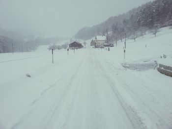 Snow covered land against sky