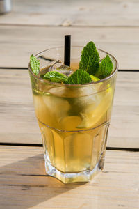 Close-up of iced long drink with mint in glass