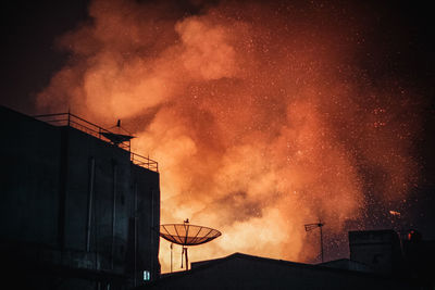 Low angle view of silhouette building against sky at night