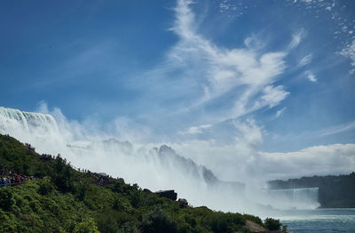Scenic view of waterfall against sky