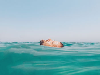 Swimming pool in sea against clear sky