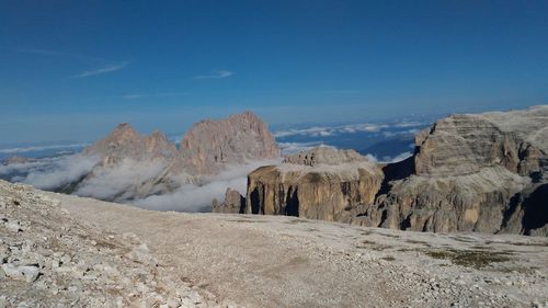 Scenic view of rocky mountains against blue sky