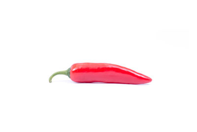 Close-up of red chili pepper against white background