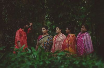 Group of people against plants