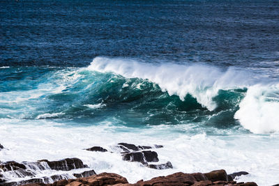 Waves splashing on rocks at shore