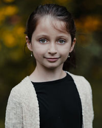 Portrait of smiling girl standing outdoors