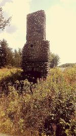 Built structure on field against sky