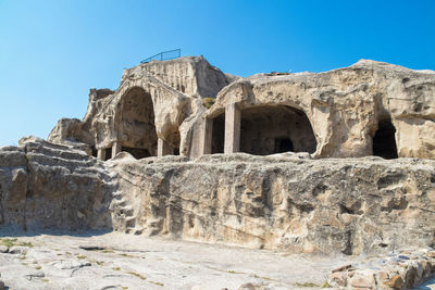 Low angle view of old ruins against blue sky