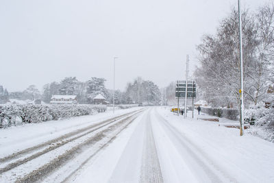 Snow covered road against sky