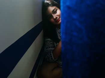 Young woman standing at home