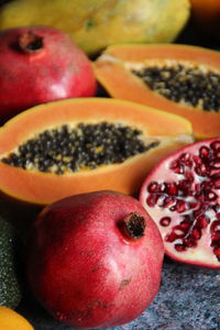 Close-up of fruits on table, grenade, turmeric, cut papaya , cachi