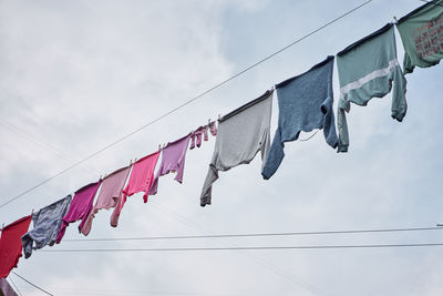 Low angle view of flags against sky