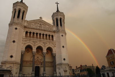 Low angle view of church against cloudy sky