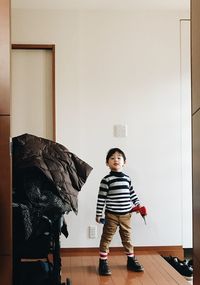 Portrait of cute boy standing on floor