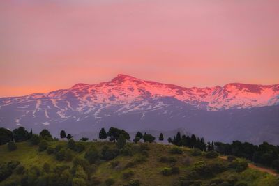 Scenic view of snowcapped mountains against sky during sunset