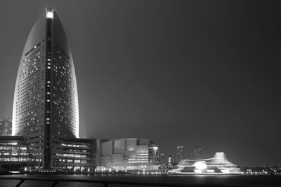 Illuminated buildings against sky at night