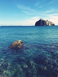 Scenic view of sea against blue sky