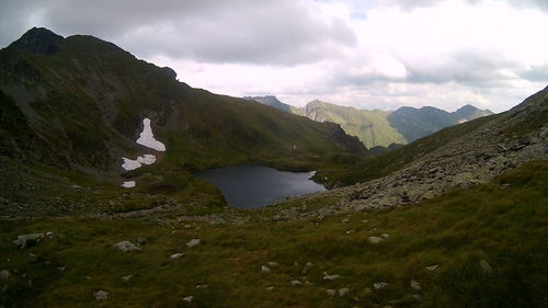 Scenic view of lake and mountains against sky