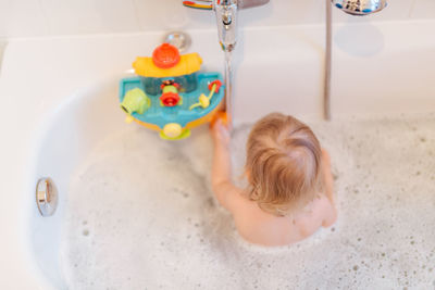 High angle view of baby boy in bathroom