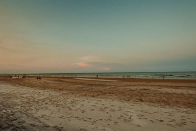 Scenic view of beach against sky during sunset