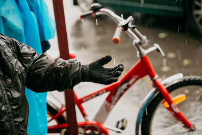 A boy during bicycle ride when it started to rain hard.