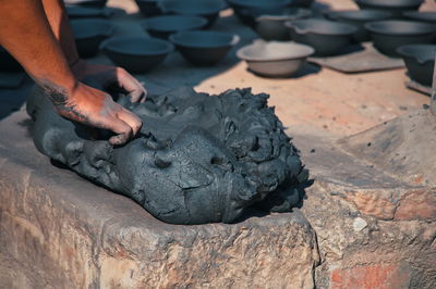 Midsection of professional potter working with clay on the square in kathmandu, nepal