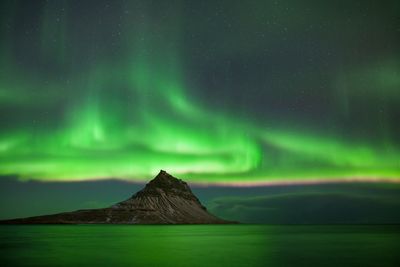 Scenic view of mountain against sky at night