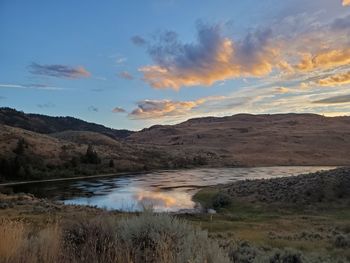 Scenic view of lake against sky during sunset