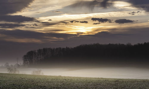 Scenic view of field against sky during sunset