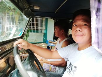 Young woman sitting in car