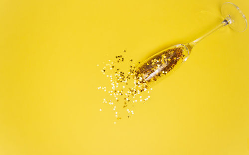 Close-up of water drops on yellow glass