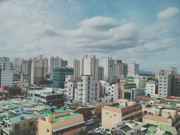 Cityscape against cloudy sky