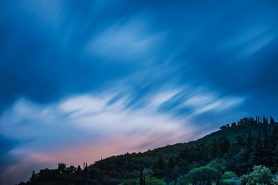 Low angle view of mountain against blue sky