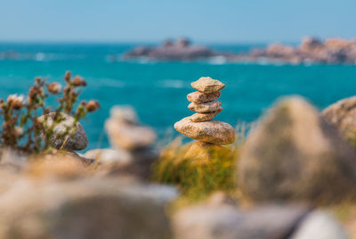 Close-up of pebbles on beach against sky