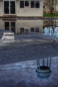 Reflection of building in puddle