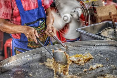 Man preparing food at market stall