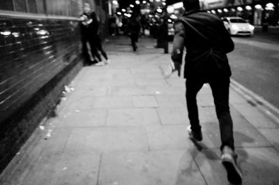 Low section of man standing on zebra crossing