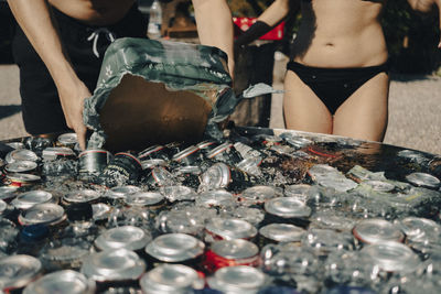 Close up of refilling a ice cold watertank with cans