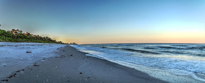 Scenic view of beach against sky during sunset