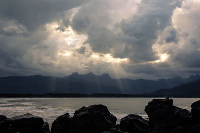 Scenic view of sea and mountains against sky