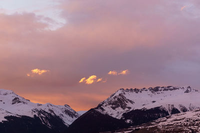 Scenic view of snowcapped mountains against sky during sunset