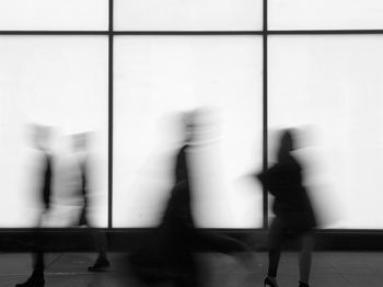Blurred motion of people walking in corridor