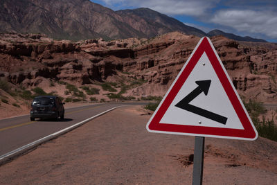 Road sign against mountains