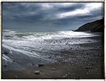 Scenic view of sea against cloudy sky