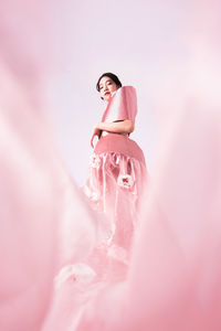 Woman standing on pink flower