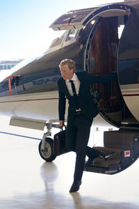 Businessman disembarking from airplane