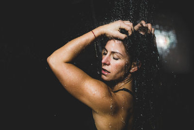 Beautiful woman taking a shower after spa center sauna.